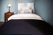 Lit de la chambre bleue, chambre d'hôtes au Château Armand Heitz en Bourgogne